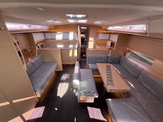 Slide: The Image of Spacious interior of 2024 Dufour 470 yacht with modern furnishings and ample seating. - 9