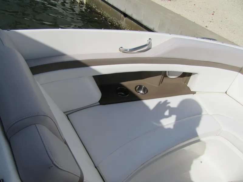 Slide: The Image of Interior seating of a 2011 Sea Ray 250 SLX boat, featuring white and brown upholstery. - 15