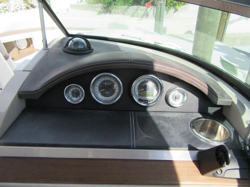 Slide: The Image of Dashboard of a 2011 Sea Ray 250 SLX boat with gauges and compass. - 20