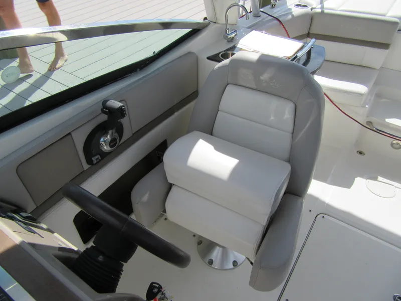 Slide: The Image of Captain's seat on a 2011 Sea Ray 250 SLX boat, featuring a sleek helm design. - 23