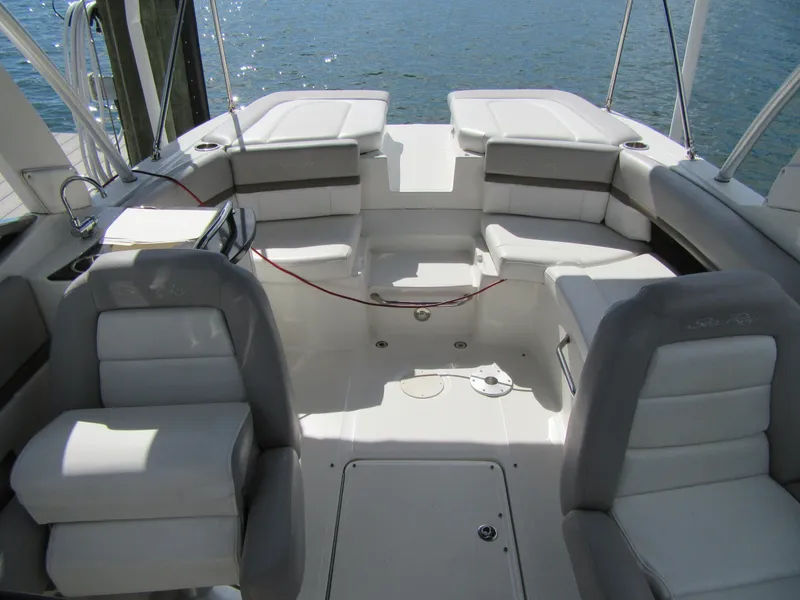 Slide: The Image of 2011 Sea Ray 250 SLX boat interior with white seating and open deck layout. - 25