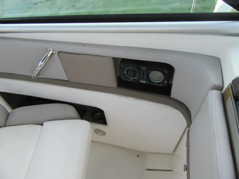 Slide: The Image of Interior of 2011 Sea Ray 250 SLX boat with audio controls and seating. - 27