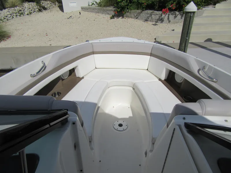Slide: The Image of 2011 Sea Ray 250 SLX boat interior with white seating and cup holders. - 28