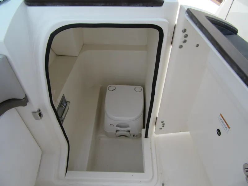 Slide: The Image of 2011 Sea Ray 250 SLX boat interior with compact marine toilet. - 30