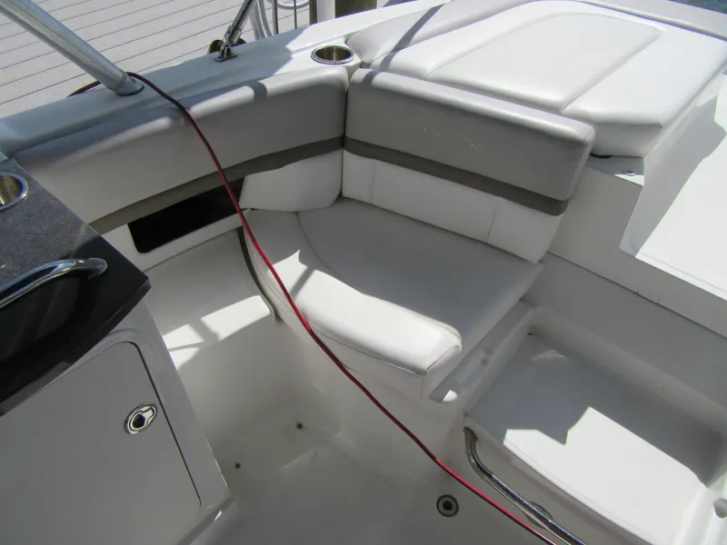 Slide: The Image of 2011 Sea Ray 250 SLX boat interior with white seating and cup holder. - 34