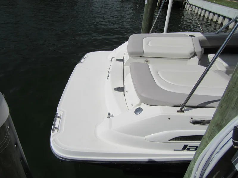 Slide: The Image of 2011 Sea Ray 250 SLX boat docked, featuring a spacious rear deck and seating area. - 37