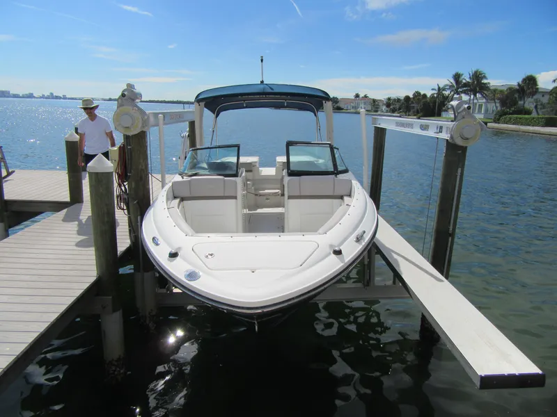 Slide: The Image of 2011 Sea Ray 250 SLX boat docked on a sunny day. - 5