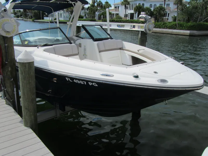 Slide: The Image of 2011 Sea Ray 250 SLX boat docked on a sunny waterfront. - 6