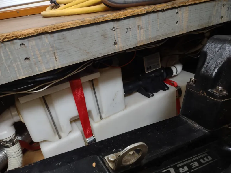 Slide: The Image of 1976 Trojan 260 Hardtop Express boat interior showing engine compartment and storage. - 10