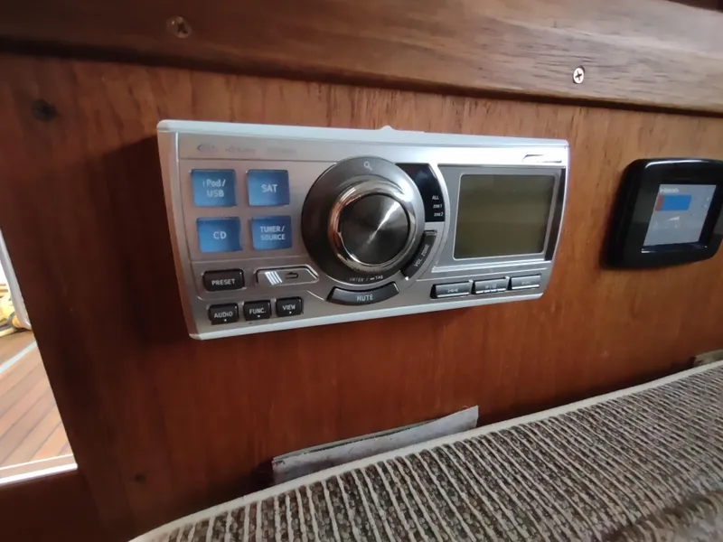 Slide: The Image of 1976 Trojan 260 Hardtop Express boat stereo system on wooden panel. - 17