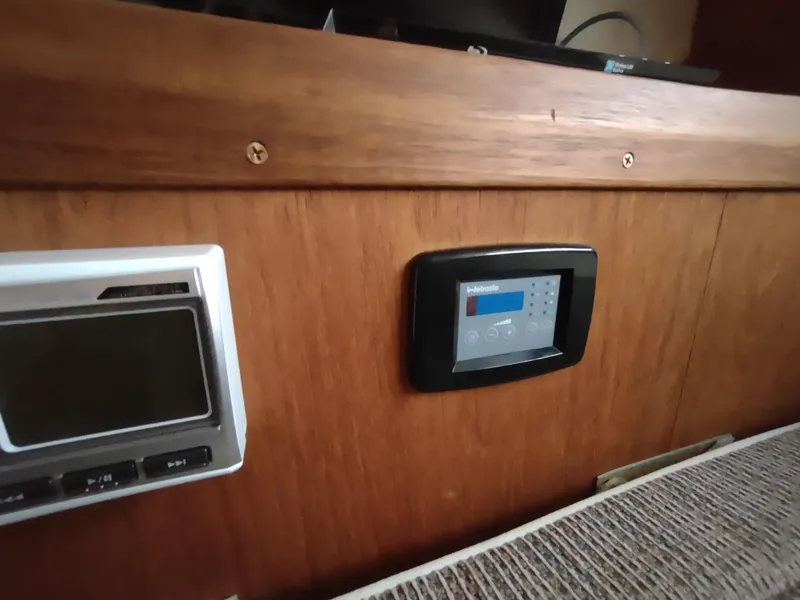 Slide: The Image of 1976 Trojan 260 Hardtop Express interior with control panels on wooden dashboard. - 18