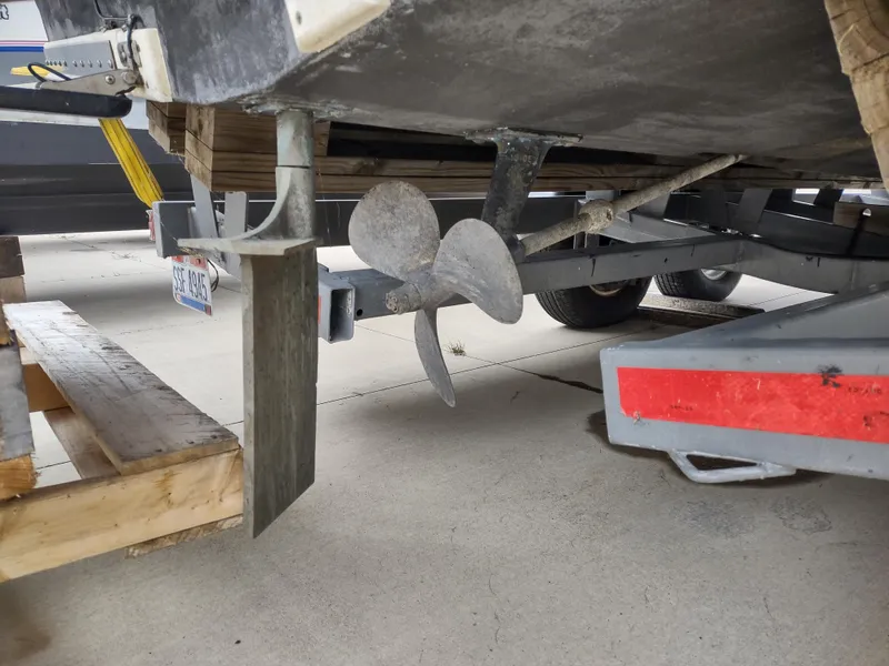 Slide: The Image of 1976 Trojan 260 Hardtop Express boat propeller and rudder on trailer. - 24