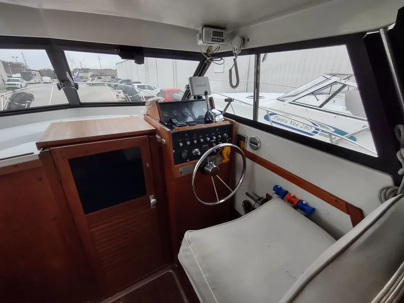 Slide: The Image of 1976 Trojan 260 Hardtop Express boat interior with steering wheel and control panel. - 5