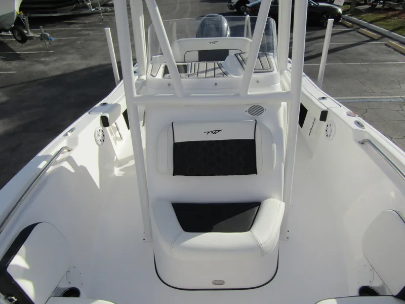 Slide: The Image of 2023 Tidewater 198 CC Adventure boat interior, white and black seating, center console. - 12