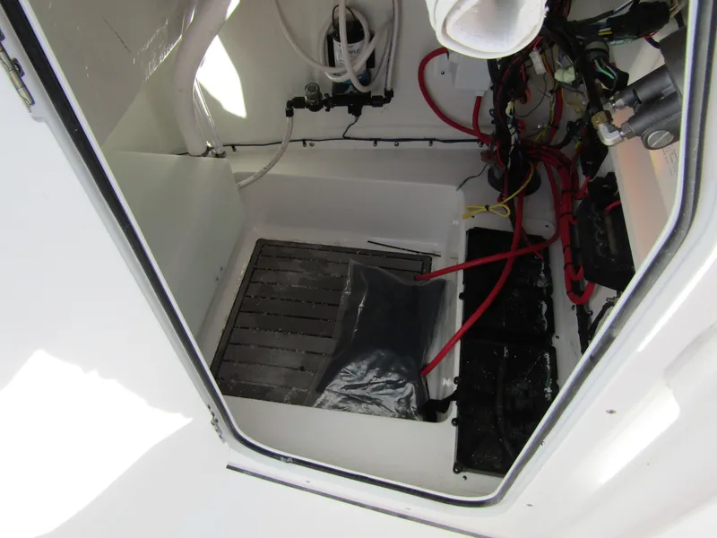 Slide: The Image of 2023 Tidewater 198 CC Adventure boat interior wiring and storage compartment. - 14
