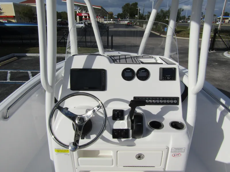 Slide: The Image of 2023 Tidewater 198 CC Adventure boat console with steering wheel and navigation controls. - 16