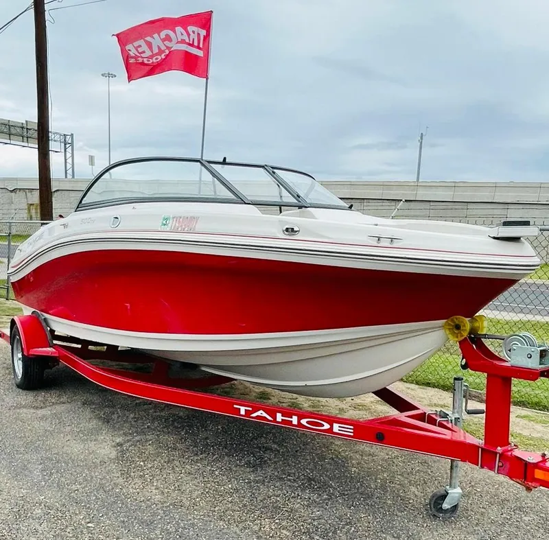 The Image of 2016 Tahoe 500 TF boat on red trailer with Tracker flag. - 0