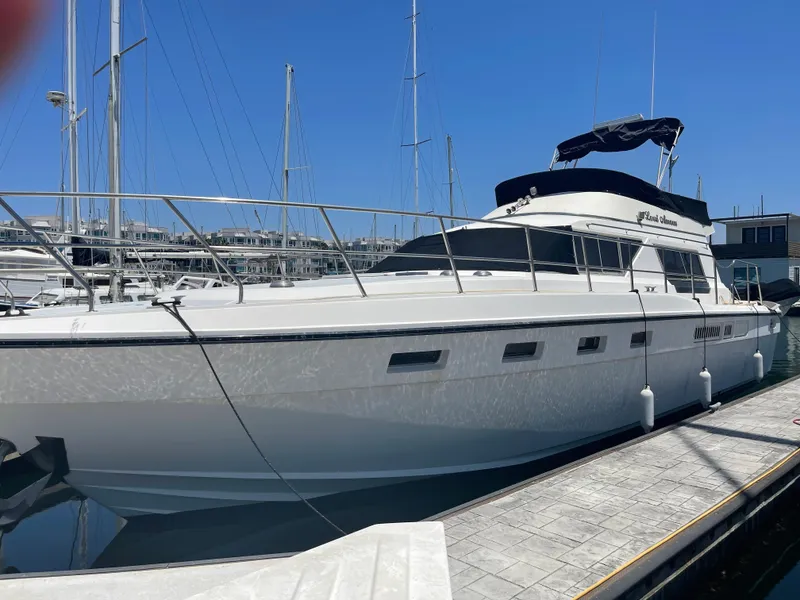Slide: The Image of 1986 Sea Hawk Sedan boat docked at marina under clear blue sky. - 1