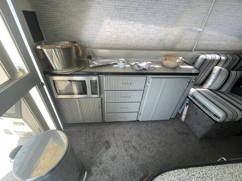 Slide: The Image of Interior of a 1986 Sea Hawk Sedan with kitchenette and striped seating. - 12