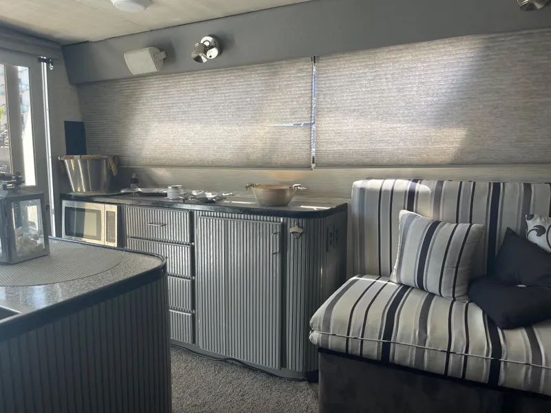 Slide: The Image of Interior of a 1986 Sea Hawk Sedan with striped seating and kitchenette. - 13