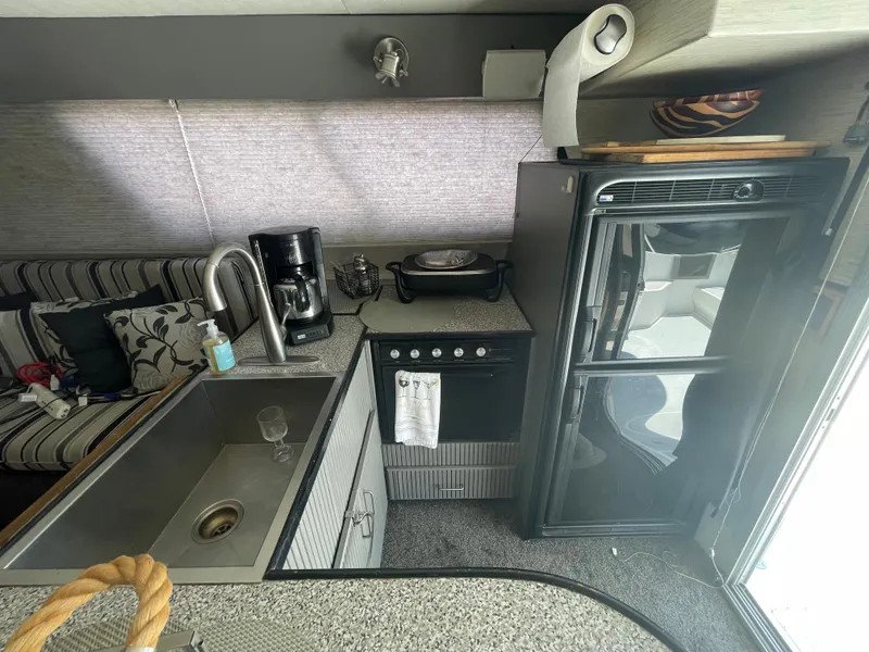 Slide: The Image of 1986 Sea Hawk Sedan kitchen with sink, stove, and refrigerator. - 18
