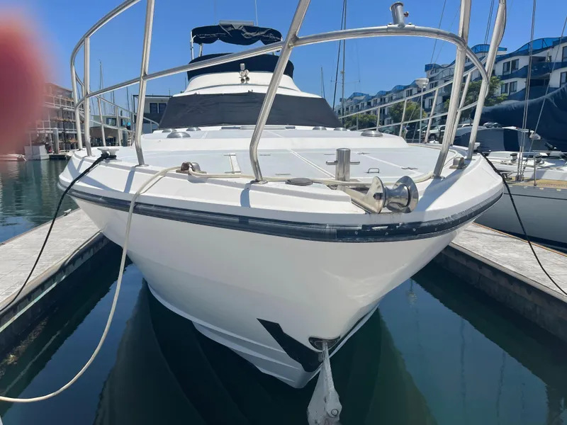 Slide: The Image of 1986 Sea Hawk Sedan boat docked in a marina, front view. - 2