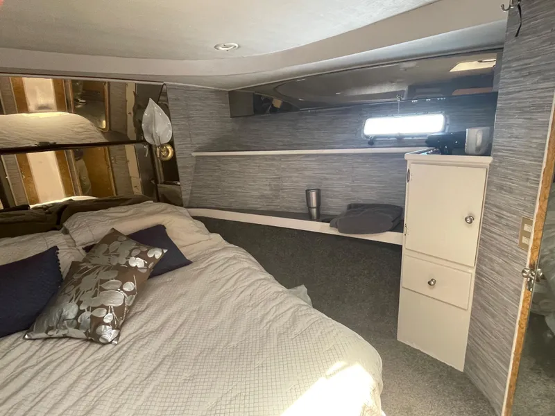 Slide: The Image of Cozy interior of 1986 Sea Hawk Sedan with bed, pillows, and storage cabinet. - 23