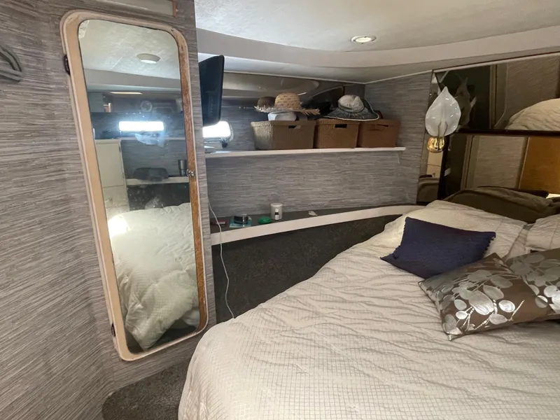 Slide: The Image of Cozy bedroom in 1986 Sea Hawk Sedan with mirror, shelves, and decorative pillows. - 24