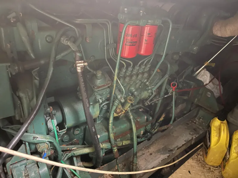 Slide: The Image of Engine compartment of a 1986 Sea Hawk Sedan with visible hoses and components. - 28