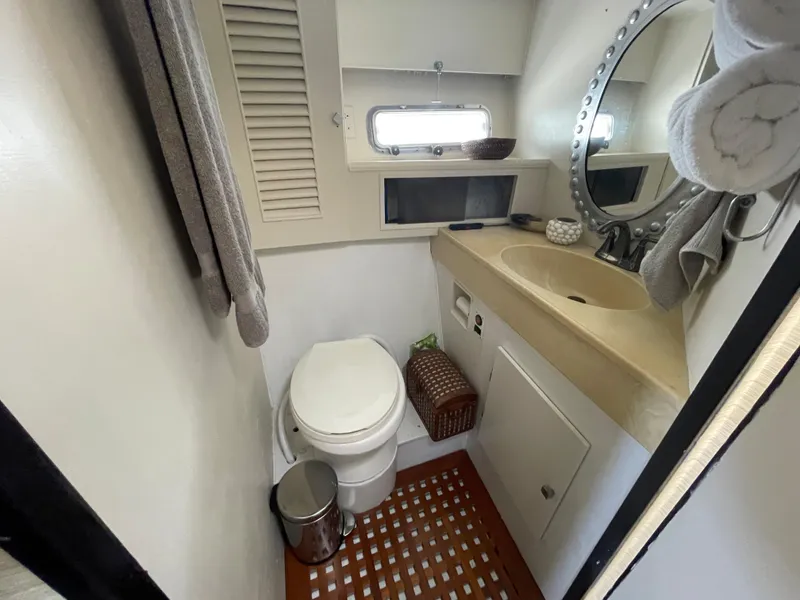 Slide: The Image of Compact bathroom in 1986 Sea Hawk Sedan with toilet, sink, and round mirror. - 33