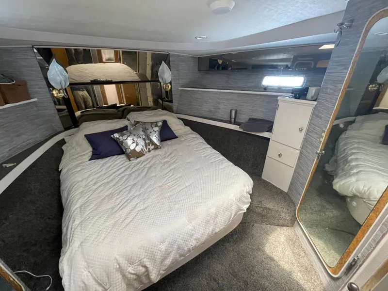 Slide: The Image of Cozy bedroom in 1986 Sea Hawk Sedan boat with mirrored headboard and elegant decor. - 36