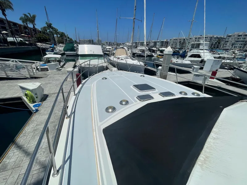 Slide: The Image of 1986 Sea Hawk Sedan boat docked in a marina with other vessels. - 4