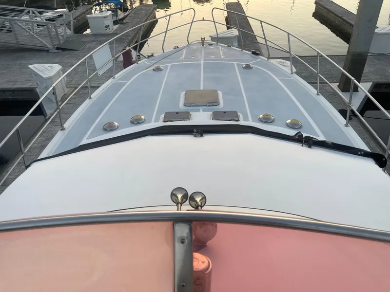 Slide: The Image of 1986 Sea Hawk Sedan boat docked at marina, viewed from the bow. - 46