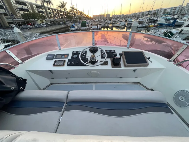 Slide: The Image of 1986 Sea Hawk Sedan boat helm with marina view at sunset. - 47