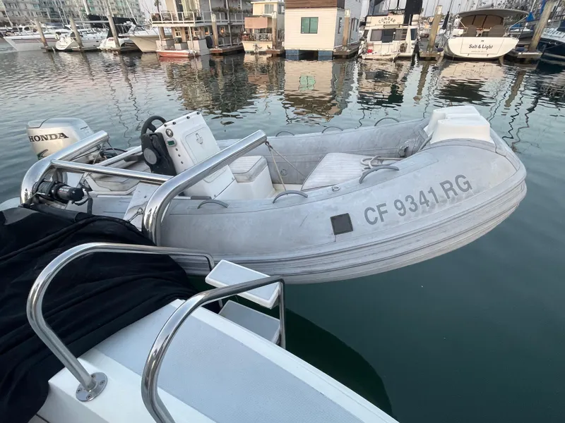 Slide: The Image of Inflatable boat docked at marina, featuring Honda motor and registration CF 9341 RG. - 48