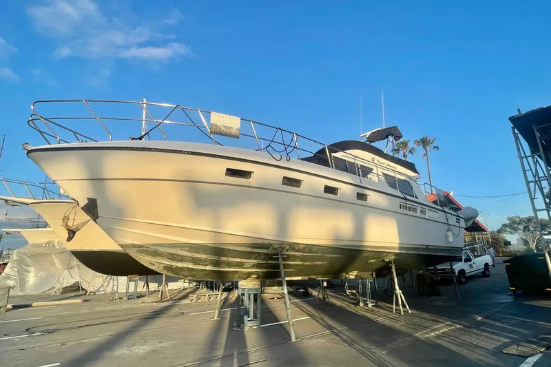 Slide: The Image of 1986 Sea Hawk Sedan boat on dry dock under clear blue sky. - 55