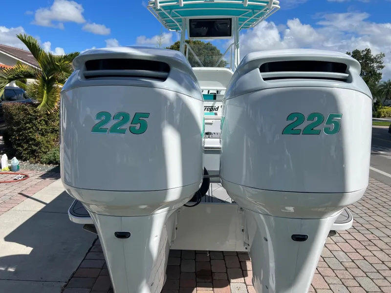 Slide: The Image of Twin 225 horsepower engines on a 1987 Intrepid 300 Center Console boat. - 11