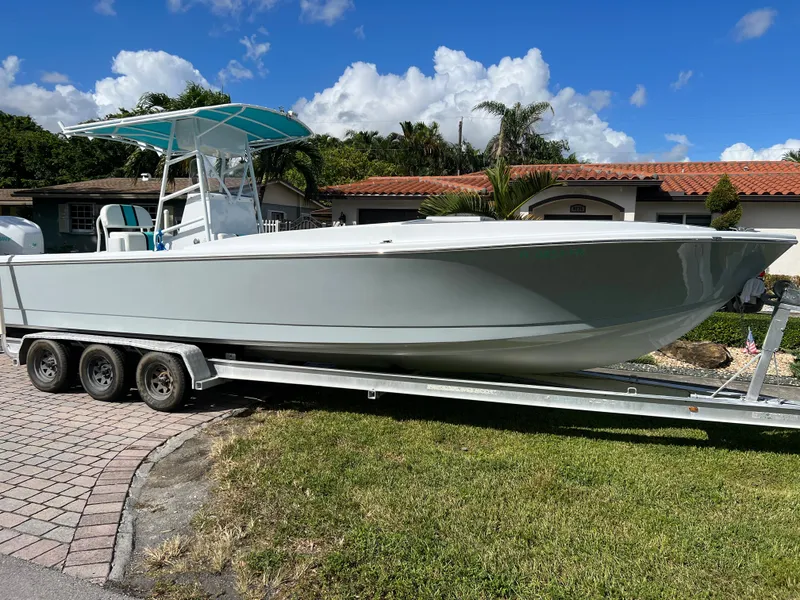 Slide: The Image of 1987 Intrepid 300 Center Console boat on a trailer in a residential driveway. - 17