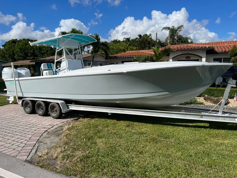 Slide: The Image of 1987 Intrepid 300 Center Console boat on a trailer in a residential area. - 19