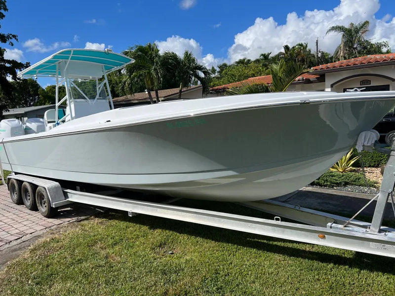 Slide: The Image of 1987 Intrepid 300 Center Console boat on a trailer, parked outdoors. - 22