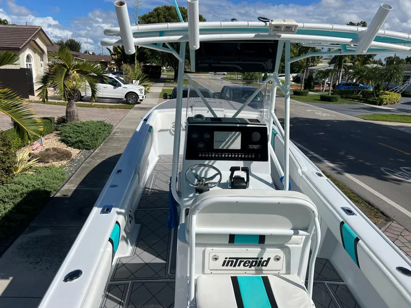Slide: The Image of 1987 Intrepid 300 Center Console boat with modern dashboard and seating. - 27