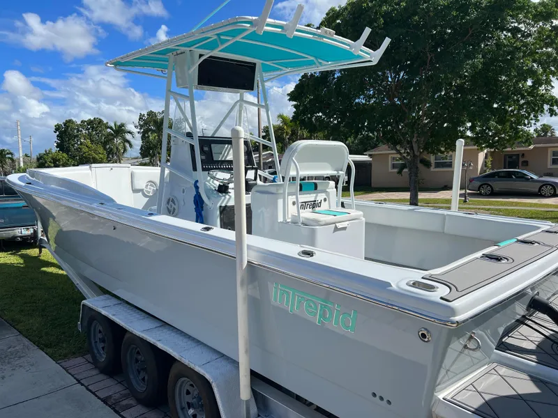 Slide: The Image of 1987 Intrepid 300 Center Console boat on a trailer, parked outdoors. - 3