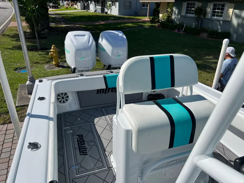 Slide: The Image of 1987 Intrepid 300 Center Console boat with twin engines and teal-striped seating. - 36