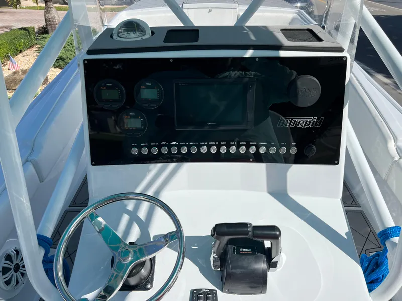 Slide: The Image of 1987 Intrepid 300 Center Console boat dashboard with steering wheel and control panel. - 41
