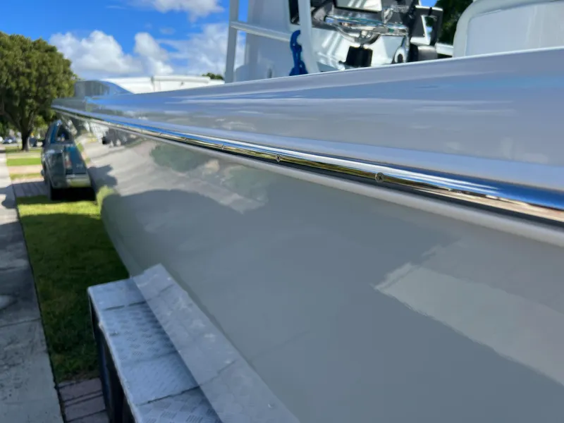 Slide: The Image of 1987 Intrepid 300 Center Console boat side view with chrome detailing. - 5