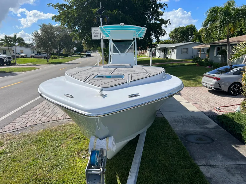 Slide: The Image of 1987 Intrepid 300 Center Console boat on trailer in residential area. - 8
