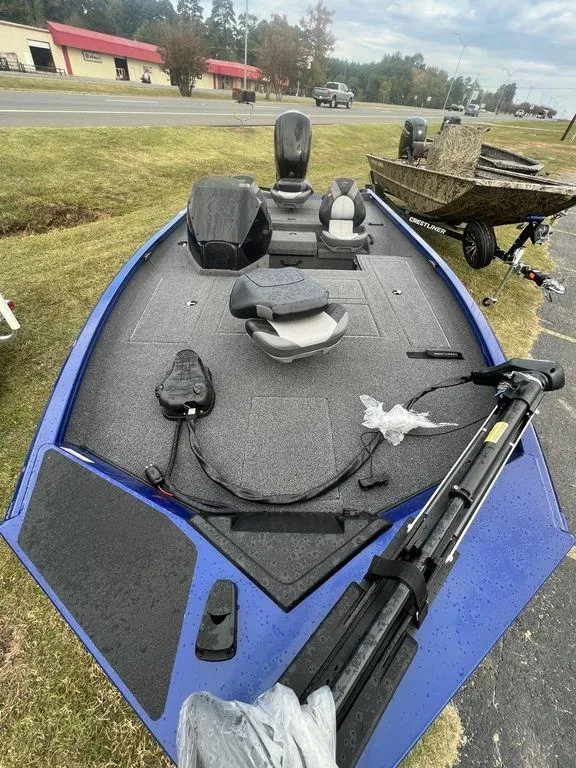 Slide: The Image of 2023 Crestliner XF 179 fishing boat with blue accents on display outdoors. - 5