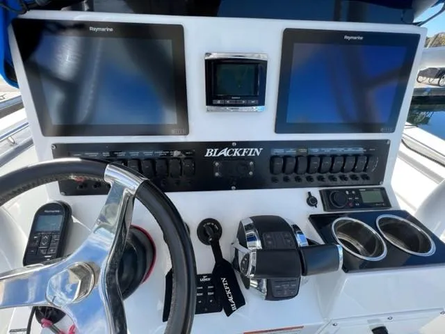 Slide: The Image of 2019 Blackfin 242 CC boat dashboard with dual Raymarine displays and controls. - 3