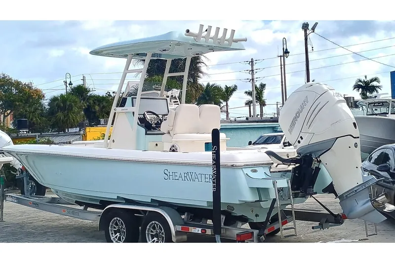 Slide: The Image of 2023 ShearWater 260 SS boat on trailer with Mercury outboard motor. - 1