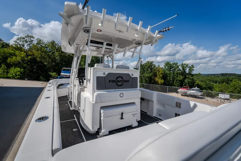Slide: The Image of 2023 Fountain 34 Tournament Edition boat with sleek design, docked outdoors under blue sky. - 40